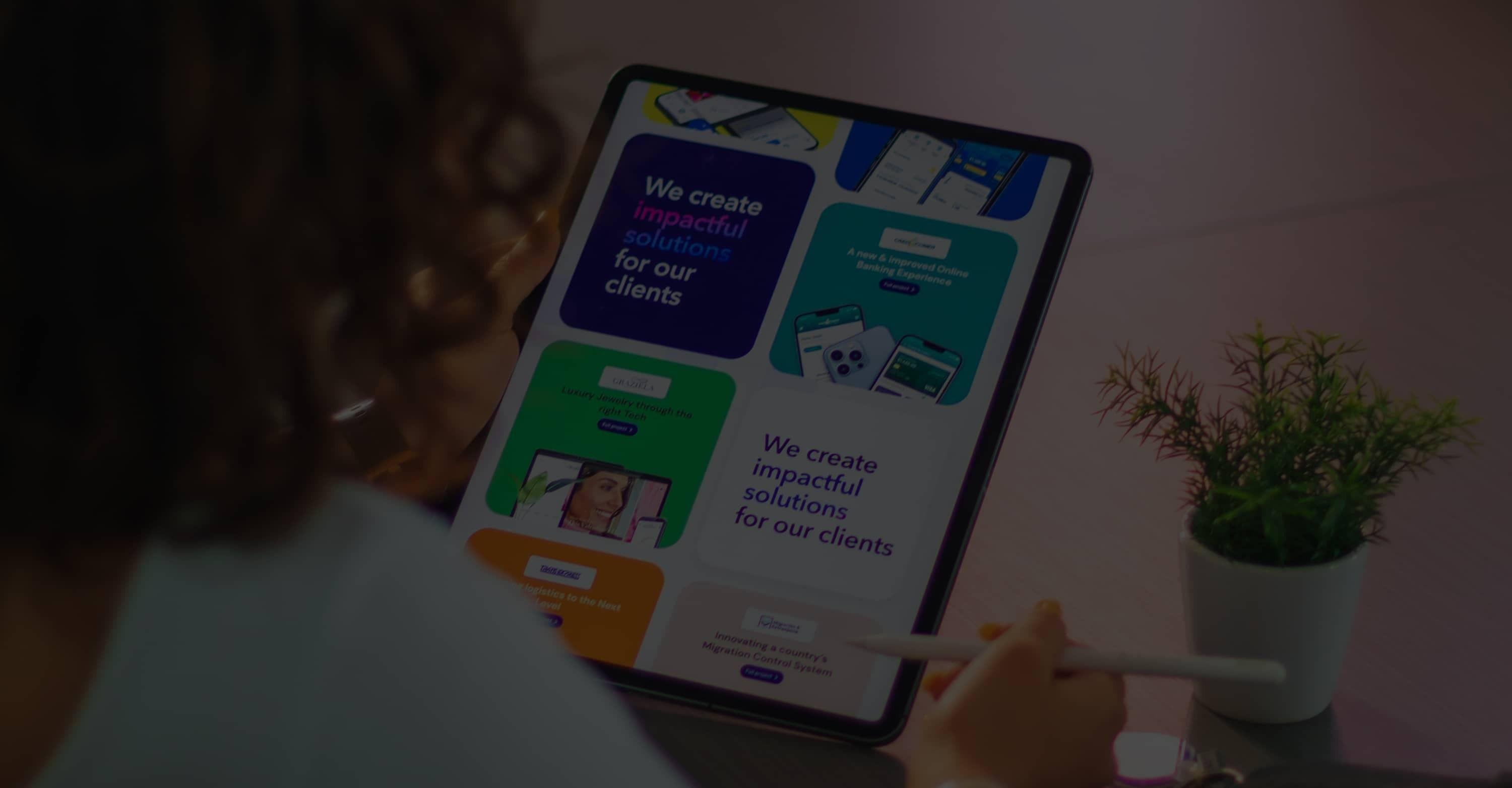 Woman looking at tablet with the Elaniin website in portrait mode